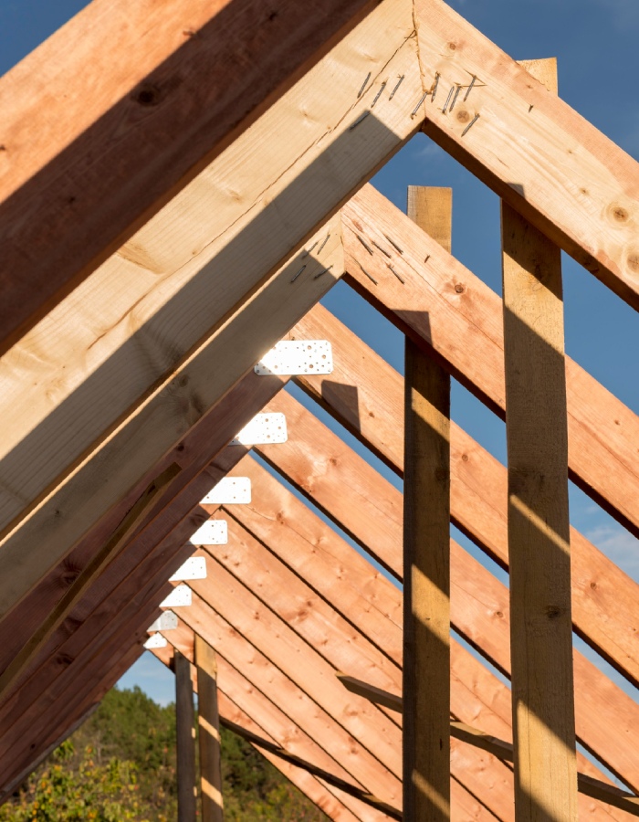 Détail d’assemblage de charpente en bois avec chevrons et fixation de la ferme